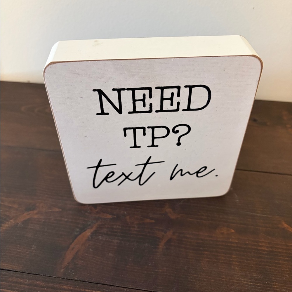 White Wooden Sign with Black Text